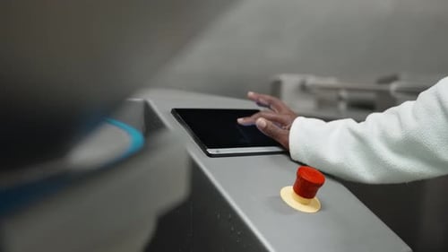 Hand using touchscreen interface, industrial control panel