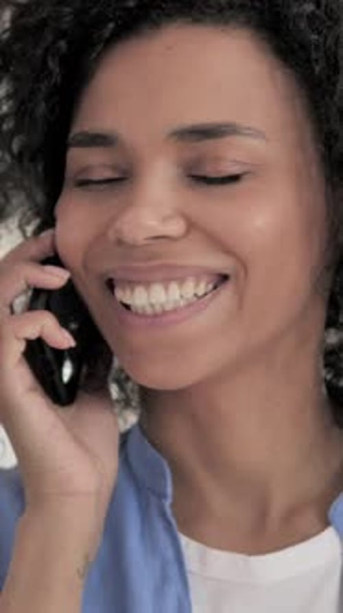 Woman Smiling While Talking on Phone, Vertical Video