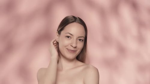Smiling Woman Touching Hair in a Fashion Portrait
