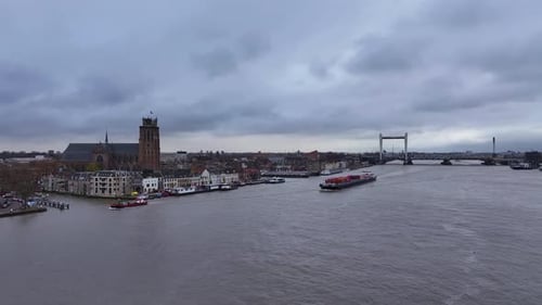 Picturesque cityscape, impressive architecture, container vessel sails onward