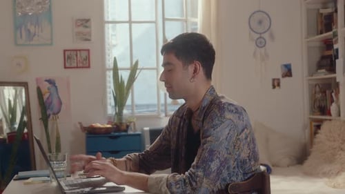 Young Adult Male Using Laptop at Home