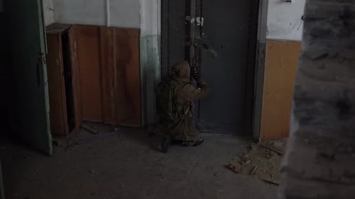A Male Stalker Breaks Open a Door in an Abandoned Factory Building