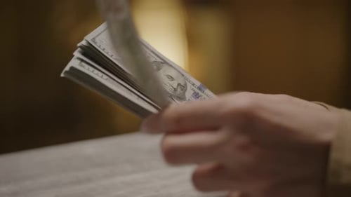 Counting Stack of One Hundred Dollar Bills