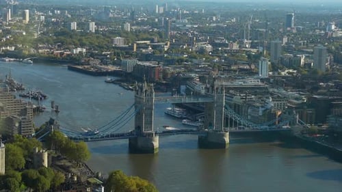Tower Bridge spanning the Thames River in London on a clear day with cityscape in the background