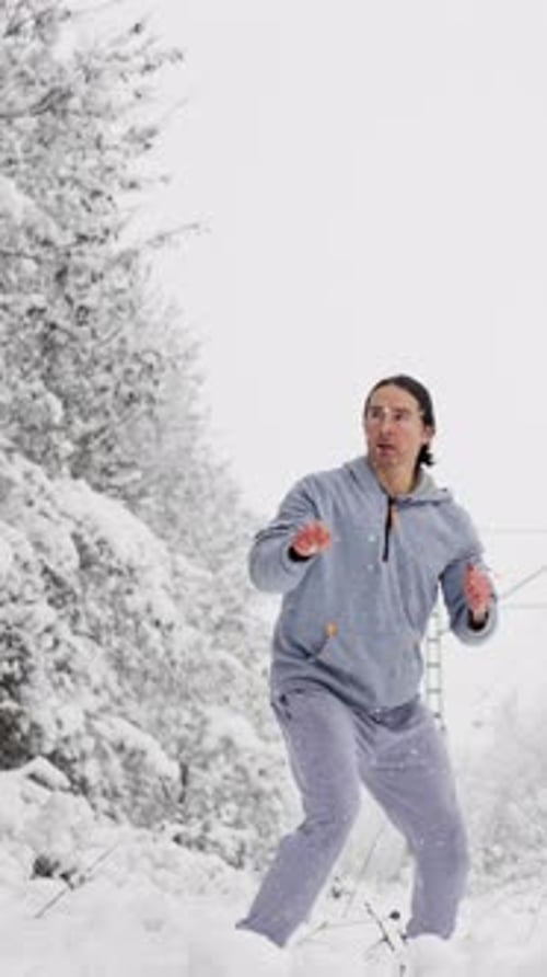 Man Practicing Martial Arts in Snowy Winter Landscape