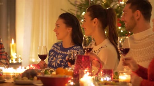 Friends and Family Celebrate Christmas Together with Wine
