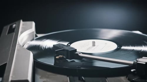Hand Places Needle on Vinyl Record Player
