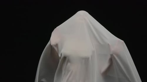 Draped Figure in White Fabric Flowing
