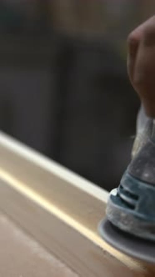 Using Orbital Sander To Polish Wooden Surface Dust Rises As Worker Crafts Smooth Wood Finish