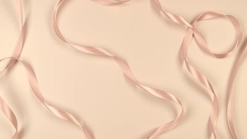 Beige Festive Delicate Pastel Background with Satin Ribbons the Concept of the Birthday of a Newborn