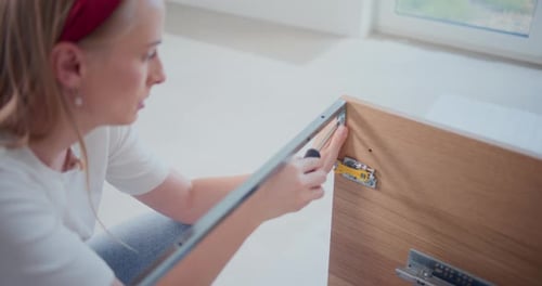 Woman Assembling Furniture in Her Home