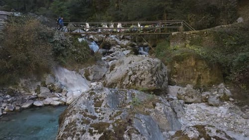 Aerial view of a hiker crossing a bridge on the Everest base camp trek in Nepal