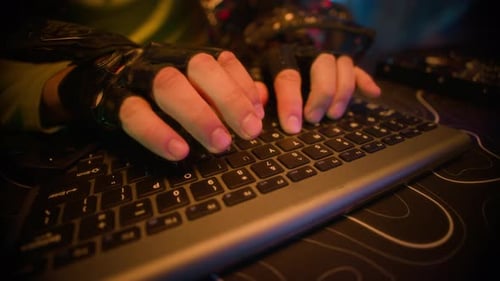 Man Wears Futuristic Glasses and Types on Keyboard