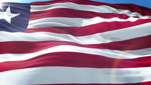 Seamless Loop of Liberia National Flag Waving in Sunny Blue Sky