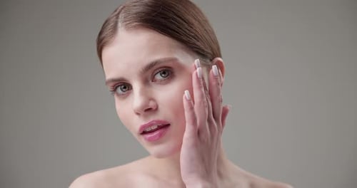 Young Woman Posing and Touching Face