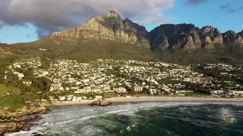 High Altitude Dolly Shot at Cape Town's Camps Bay Beach with Table Mountain in the Background at Gol