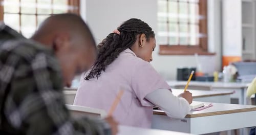Girl, students and classroom with test, education and writing with assessment