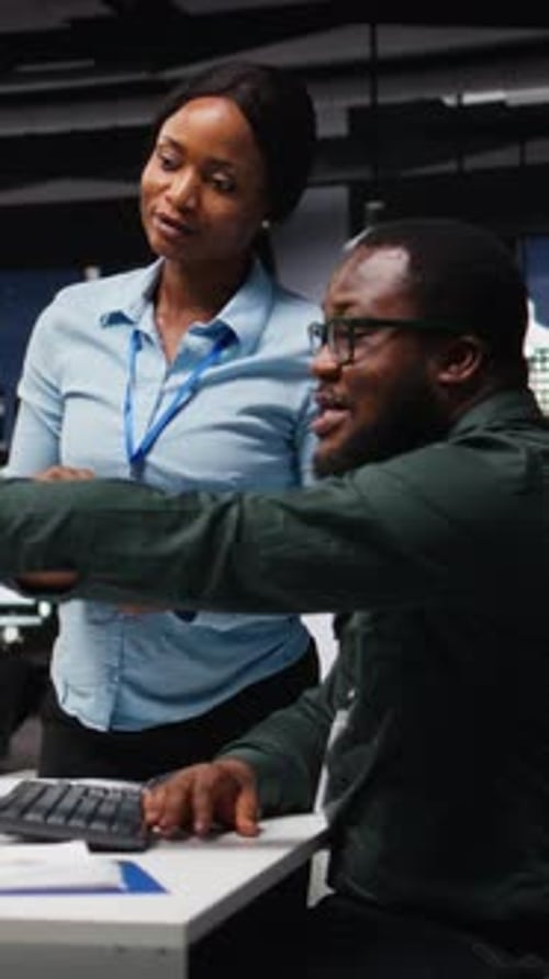 Vertical Video African American Workers Team Consulting Each Other in Solving Tasks at Night