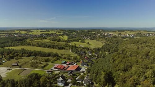 Drone Flight Over a Village Near Forest and Fields in Summer