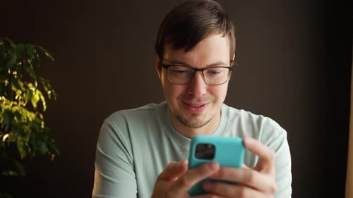 Man Using Smartphone Indoors