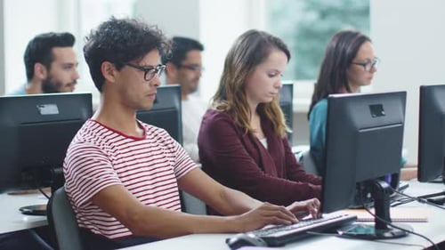 Group of Mixed Race Students are Working on Computers in Classroom