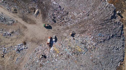 Aerial View of a Vast Landfill Where Bulldozers are Working and Trucks are Bringing New Waste Huge