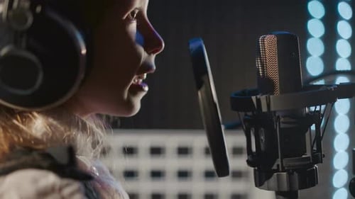 Smiling Child Sings in Audio Studio Closeup