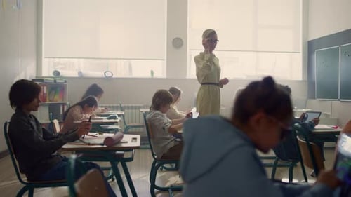 Children in classroom with teacher working at desks