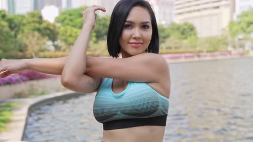 Active Woman Stretching Arms in the Park