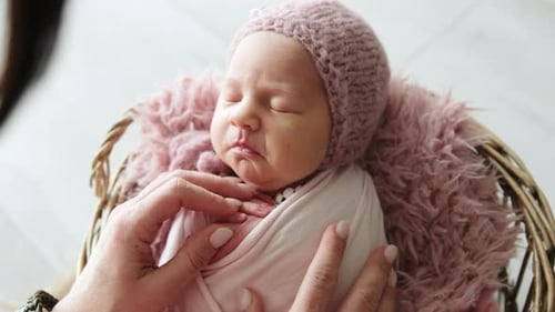 Peaceful Newborn Baby Sleeps in a Wicker Basket