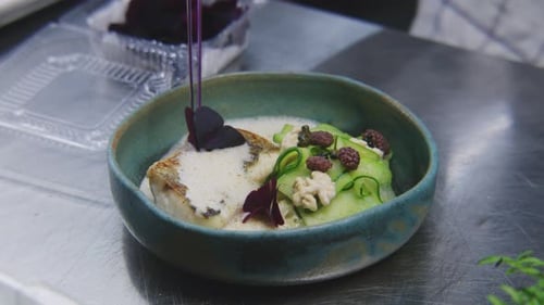 Chef Garnishing an Elegant Fish Dish with Flowers