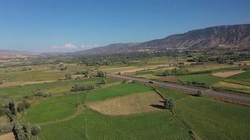 Vue aérienne de l'autoroute, des terres agricoles et des collines