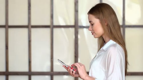 Elegant young woman using a mobile device