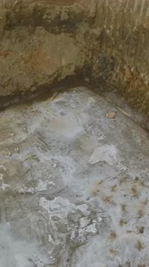 Vertical Video Builders Pour Concrete Into the Foundation Laying the Base for a Modern Residential