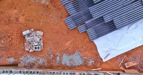 Construction Site with Materials and Debris on the Ground in a Developing Area