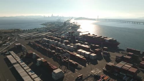 Logistics and Transportation of Container Cargo Ship with Working Crane Bridge in Shipyard