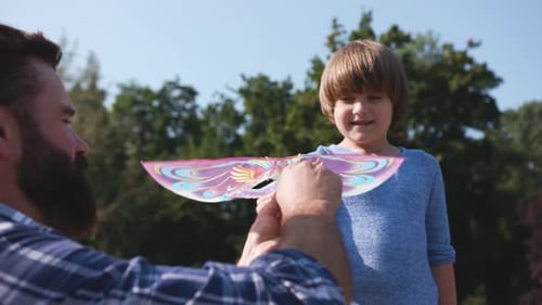 Father and Son Playing with a Toy Kite