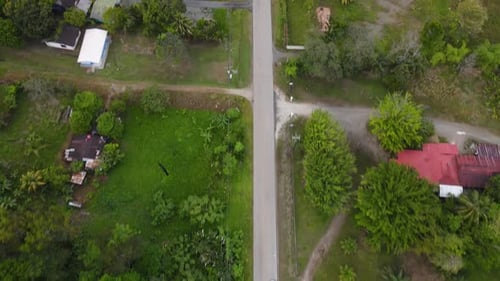 Aerial shot of car driving through a rural landscape in Costa Rica