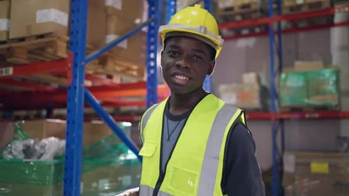 Portrait of African man industry worker working in factory warehouse.