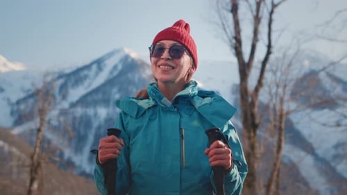 Woman Hiker Poses on Snowy Mountain