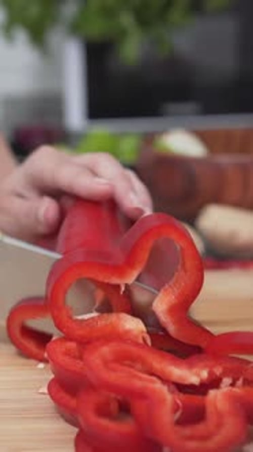 Girl Slicing Red Bell Pepper On Chopping Board Close Up