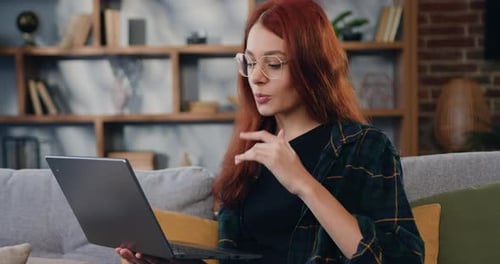 Woman Using Laptop for Video Call at Home