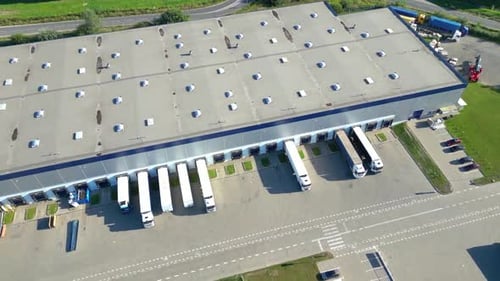 Aerial Perspective of Semi Trucks at Modern Logistics Distribution Center