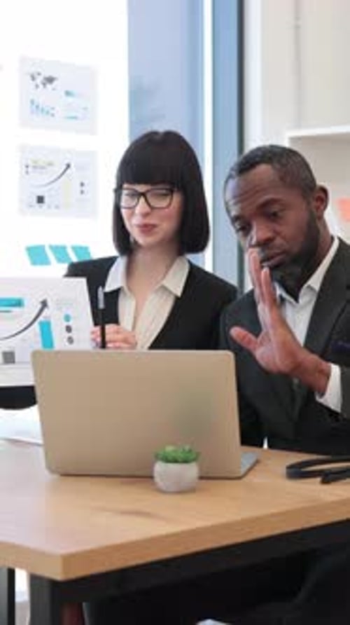 Business Team Reviewing Data in Office Setting