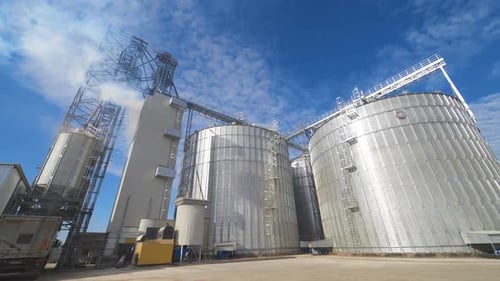 Grain Silos Under Blue Sky