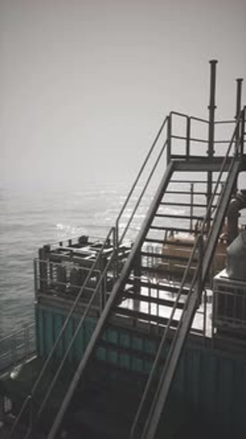Exploring the Vast Expanse Near a Towering Oil Rig Under a Cloudy Sky