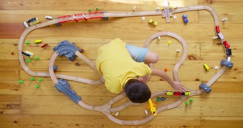 Child Plays with a Wooden Train Set