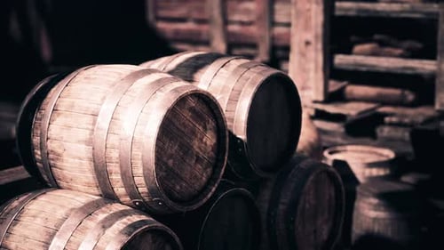 Rustic Wooden Barrels Stacked in an Old Warehouse During Afternoon Light