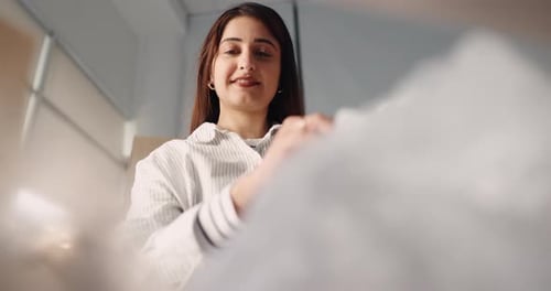 Woman unpacking items from a cardboard box