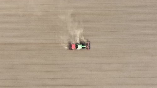 Agricultural transport. Tractor in the field. Working the land. Aerial view of the field.